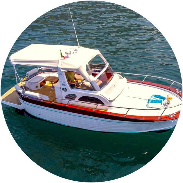 White motorboat with canopy on water, viewed from above.