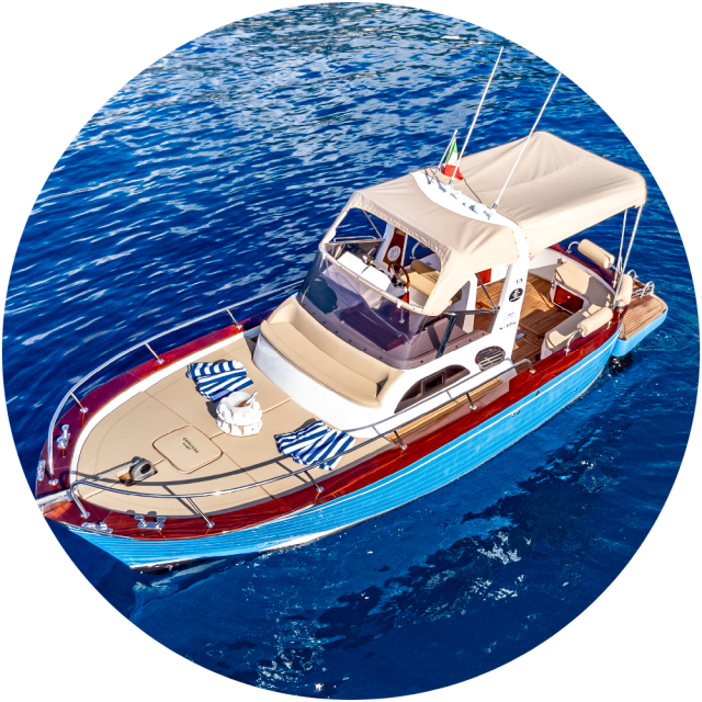 Aerial view of a boat with canopy on blue water, towels on deck.